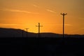 Telephone Poles Silhouette Against an Orange Sky Royalty Free Stock Photo