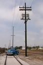 Telephone poles, train track, truck