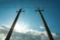 Telephone poles and wires against blue sky with clouds Royalty Free Stock Photo