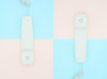 Telephone receiver on blue and pink background. Royalty Free Stock Photo