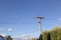 Telephone wires against a blue sky