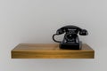 Telephone on wooden shelf