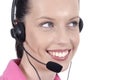 Close up female telephonist with telephone headset smiling, looking away from camera