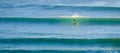 A man foil surfing on a backlit wave in imsouane,morocco