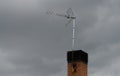 Telephoto view of television aerials mounted on chimney Royalty Free Stock Photo