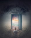 Teleportation door to your hidden dreams. A person in a dark land in front of a doorway as portal leading to a tropical beach with