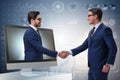 The telepresence concept with two businessman handshaking