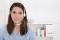 Telesales or helpdesk - helpful woman with headset smiling at ca