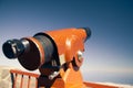 Telescope against blue sky background Royalty Free Stock Photo