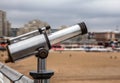 Telescope on Hague bridge in cloudy autumn day