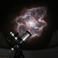 A telescope inside an observatory is positioned toward a vivid cosmic nebula. The Royalty Free Stock Photo