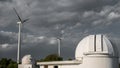 A telescope observatory dome and windmills