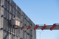 Telescopic boom of a construction truck crane with a cradle on the facade of a building, repair work, background Royalty Free Stock Photo