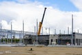 Telescopic boom crane on construction site of a new steel framework warehouse building Royalty Free Stock Photo