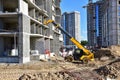 Telescopic handler work at the construction site. Construction machinery for loading. Tower crane during construct a multi-storey