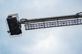 Telescopic lift of fire truck on sky background