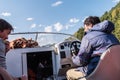 Travelers, skipper and passenger in the cockpit of a motor boat