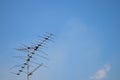 Television antenna on blue sky background