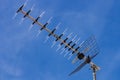 Television antenna facing left over blue sky Royalty Free Stock Photo