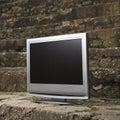 Television by brick wall. Royalty Free Stock Photo