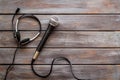 Television concept. Microphone and headset on dark wooden background top-down copy space