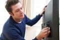 Television Engineer Installing New TV At Home