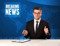 Television presenter in front telling breaking news with blue mo Royalty Free Stock Photo