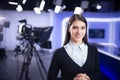 Television presenter recording in news studio. Female journalist anchor presenting business report Royalty Free Stock Photo