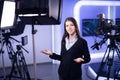 Television presenter recording in news studio.Female journalist anchor presenting business report,recording in television studio