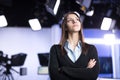 Television presenter recording in news studio. Female journalist anchor presenting business report, recording in television studio Royalty Free Stock Photo