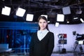 Television presenter recording in news studio.Female journalist anchor presenting business report,recording in television studio Royalty Free Stock Photo