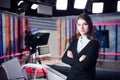 Television presenter recording in news studio.Female journalist anchor presenting business report,recording in television studio