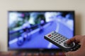 Television remote control in the hand, zapping Royalty Free Stock Photo