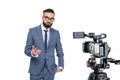 television reporter gesturing and standing in front of camera, Royalty Free Stock Photo
