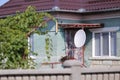 Television satellite receiver antenna on a house in a village in rural Romania Royalty Free Stock Photo