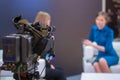 Television video camera recording interview in broadcast news studio Royalty Free Stock Photo