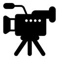 Television video camera solid icon, optical equipment concept. Vector graphics. Studio camera with microphone on tripod Royalty Free Stock Photo