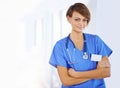 Tell me where it hurts. Portrait of a confident young doctor wearing blue scrubs. Royalty Free Stock Photo