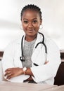 Tell me where it hurts. Portrait of a confident young doctor working in a modern hospital. Royalty Free Stock Photo