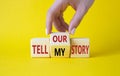 Tell our or my story symbol. Businessman hand turns wooden cubes and changes the words Tell my story to tell our story. Beautiful Royalty Free Stock Photo