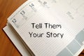 Tell them your story write on notebook Royalty Free Stock Photo