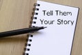 Tell them your story write on notebook Royalty Free Stock Photo