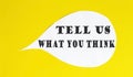 Tell Us What You Think speech bubble isolated on the yellow background