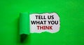 Tell us what you think symbol. Words `tell us what you think` appearing behind torn green paper. Business and `tell us what you Royalty Free Stock Photo