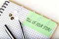 TELL US YOUR STORY on post note for remind on the stickers with pen Royalty Free Stock Photo
