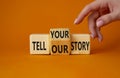 Tell Your or Our story symbol. Businessman hand points at turned wooden cubes with words Tell your story to Tell our story. Royalty Free Stock Photo