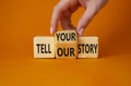 Tell Your or Our story symbol. Businessman hand turns wooden cubes and changes the words Tell your story to Tell our story. Royalty Free Stock Photo