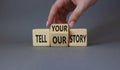 Tell Your or Our story symbol. Businessman hand turns wooden cubes and changes the words Tell your story to Tell our story. Royalty Free Stock Photo