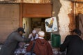 Street scene in the village of Telouet, in the Atlas Region of Morocco, with men buying meat in a butcher shop Royalty Free Stock Photo