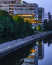 The Teltow Canal in Berlin-Tempelhof, Germany, with view to a modern office building. Some floors are colorful illuminated. Royalty Free Stock Photo